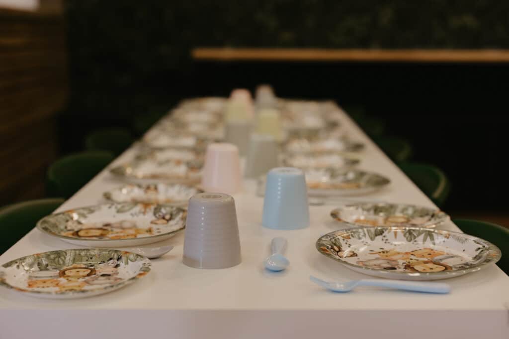 Birthday party table set with plates, cups and cutlery