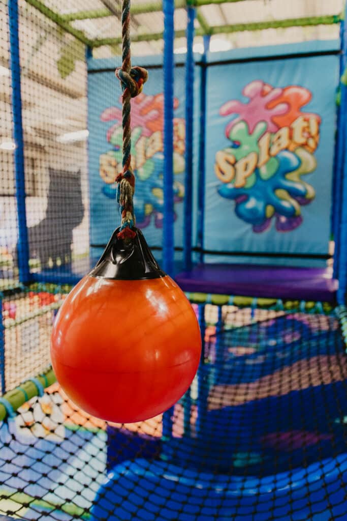 Orange hanging punching ball in the Tree House soft play area