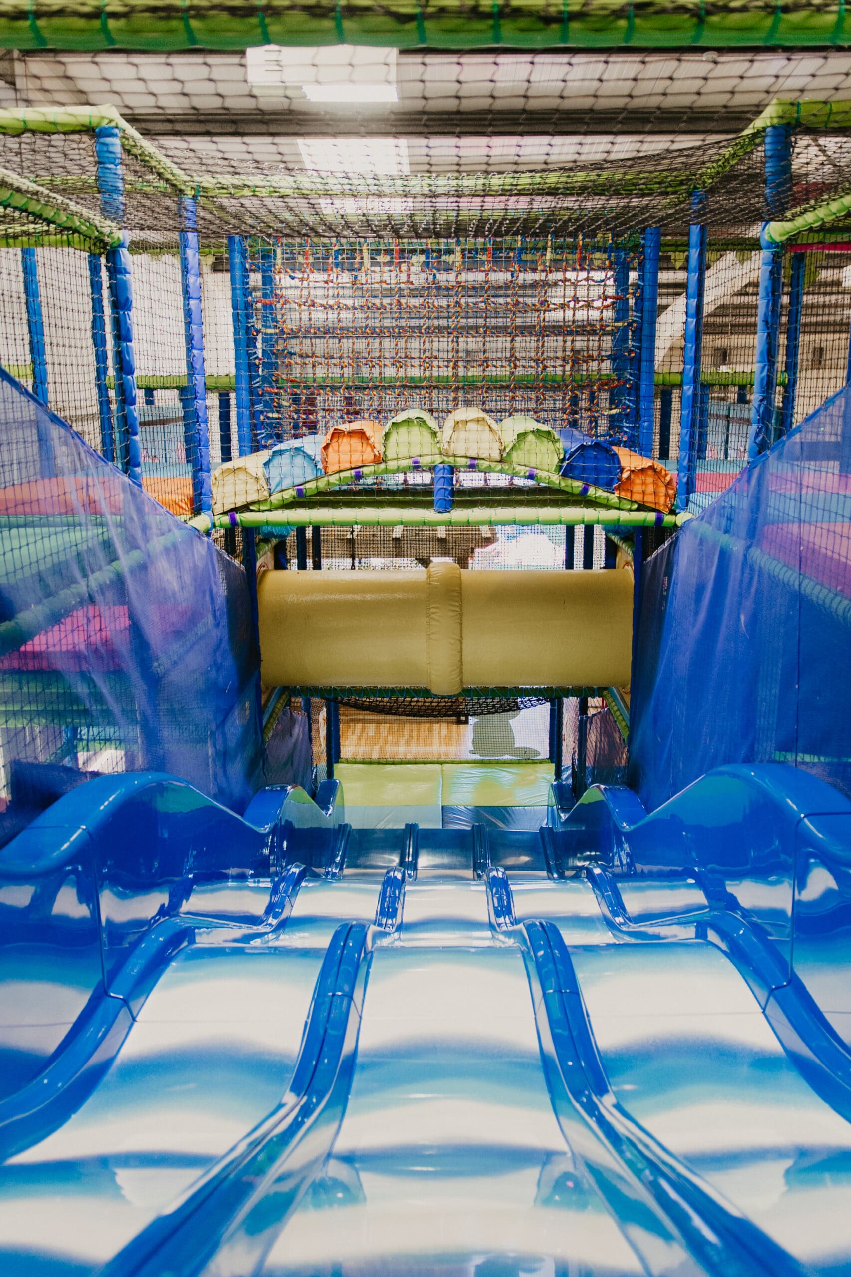 Multi-lane slide inside the indoor Tree House soft play frame