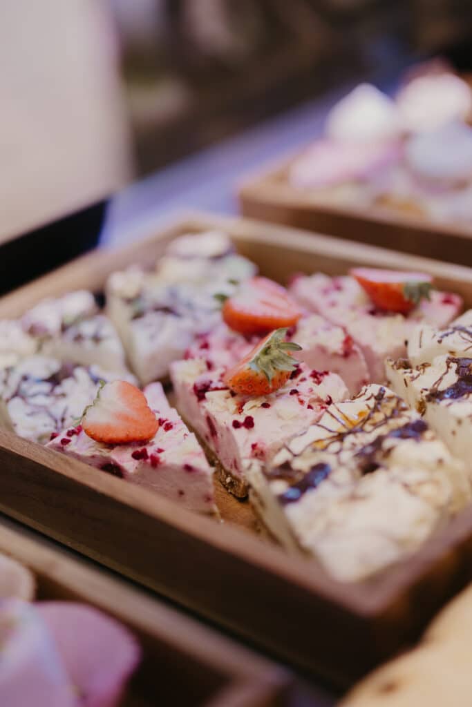 Tray of iced dessert bars topped with strawberries
