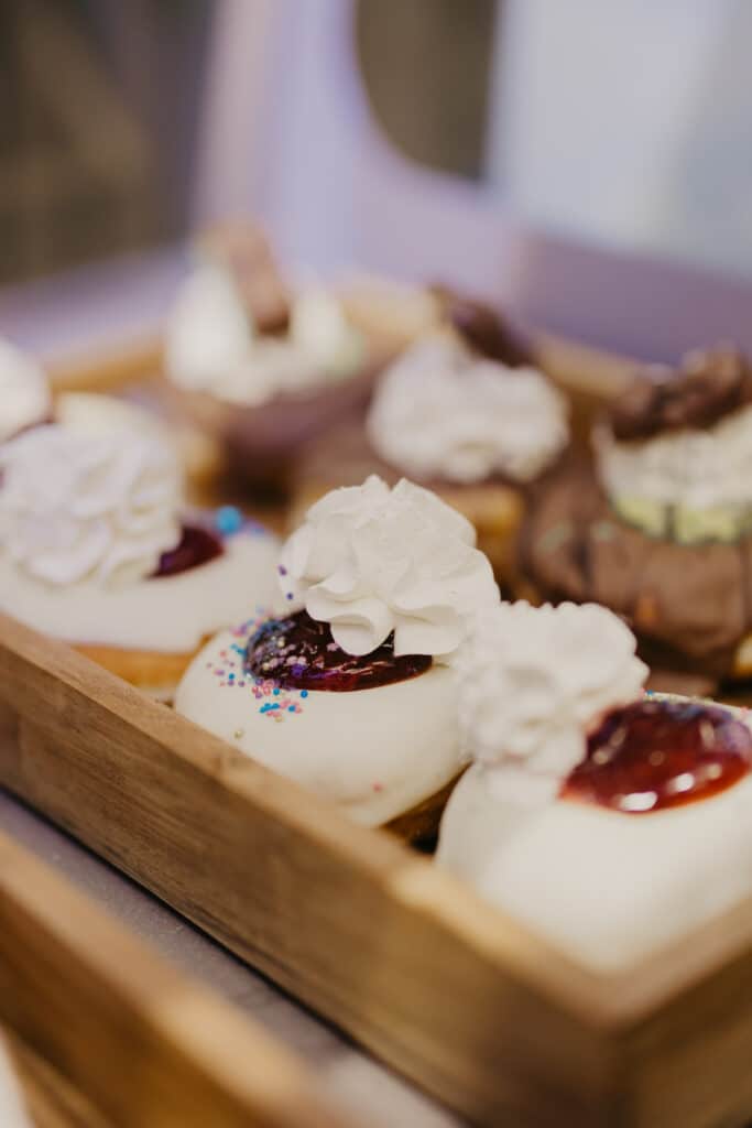 Tray of decorated cupcakes with whipped cream